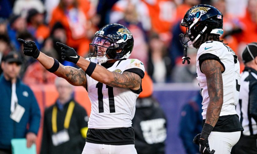Jacksonville Jaguars wide receiver Parker Washington (11) celebrates after a first down with wide receiver Jakobi Meyers (3) during a game between the Jacksonville Jaguars and the Denver Broncos at Empower Field at Mile High on December 21, 2025 in Denver, Colorado.