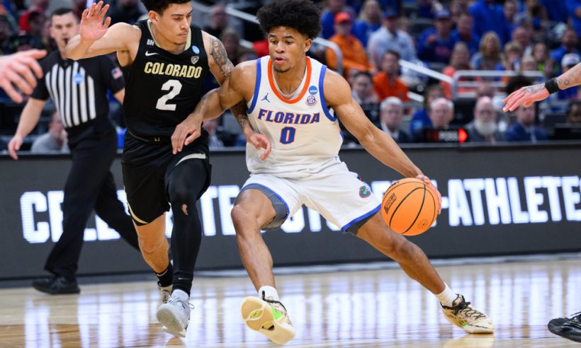 Florida Gators guard Zyon Pullin (0) drives past Colorado Buffaloes guard KJ Simpson (2) during the Colorado Buffaloes versus the Florida Gators in the first round of the NCAA Division 1 Championship on March 22, 2024, at Gainbridge Fieldhouse in Indianapolis, IN.