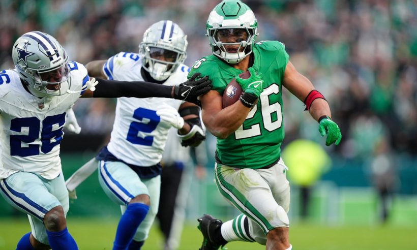 Philadelphia Eagles running back Saquon Barkley (26) carries the ball against Dallas Cowboys defensive back DaRon Bland (26) in the second half during the game between the Dallas Cowboys and Philadelphia Eagles on December 29, 2024 at Lincoln Financial Field in Philadelphia, PA.