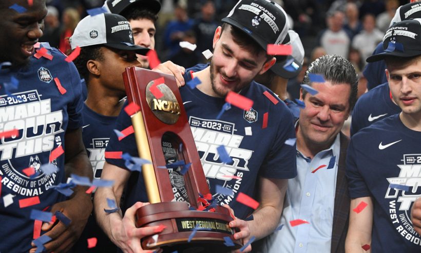 UConn Huskies forward Alex Karaban (11) holds up the trophy after advancing to the Final Four after winning the NCAA Division I Men's Championship Elite Eight round basketball game between the Gonzaga Bulldogs and the UConn Huskies on March 25, 2023 at T-Mobile Arena in Las Vegas, NV.