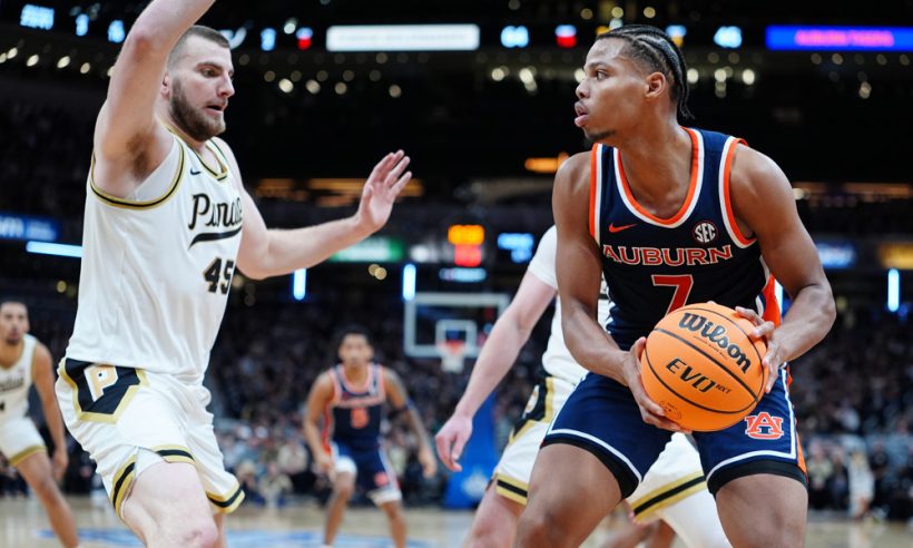 INDIANAPOLIS, IN - DECEMBER 20: Purdue Boilermakers center Oscar Cluff (45) guards Auburn Tigers forward Keyshawn Hall (7) during the Indy Classic on December 20, 2025, at Gainbridge Fieldhouse in Indianapolis, Indiana.