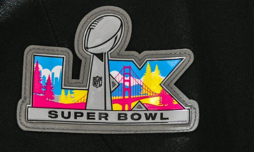 A detail view of a Super Bowl LX logo patch on New England Patriots jerseys on display for sale on January 31, 2026, at DICK’S Sporting Goods, in Dedham, MA.